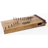 A 19thC stringed tribal style zither type instrument, of square block form with lyre carving and cru