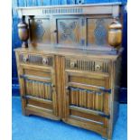 A 20thC oak court cupboard, of rectangular form, the upper section with heavy baluster supports, cen