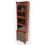 A late 19thC mahogany narrow Wernicke style cabinet, with moulded top, raised above five glazed door
