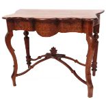 A heavily carved early 20thC North European side table, with serpentine front, on inverted cabriole