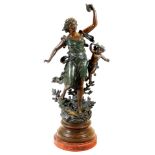 A late 19thC Poesie Lyrique cast metal figure of a lady scantily dressed, aside cherub, on a natural