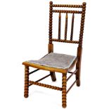 A late 19thC bobbin turned side chair, with shaped back and overstuffed seat on turned front legs, 8