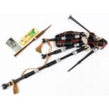 A part set of bagpipes, with turned sections and tartan bag, various other partial pipes, 59cm wide,