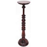 An early 20thC mahogany plant stand, the plain circular top on a turned stem terminating in a heavil