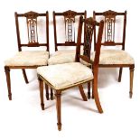 A set of four Edwardian dining chairs, each with pierced back splats, overstuffed seats in later flo