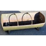 A cast iron feeding trough planter, on shaped stiles, with sectional interior, 28cm high, 21cm wide,