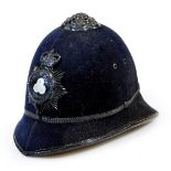 A Faux Police helmet with Lincolnshire Constabulary badge, with partial inner lining, 22cm high.