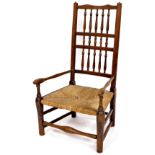 A late 19thC Lancashire style low chair, with triple bobbin turned back splat, turned arms and rush
