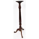 An early 20thC mahogany plant stand, the moulded circular top raised on an acanthus and fluted taper