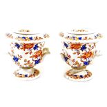 A pair of 19thC porcelain ice pales, each with liners, florally decorated on a white ground, of camp