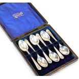 A set of six George V silver golfing related teaspoons, with golf club and ball heads, in fitted cas