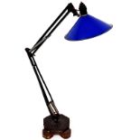A 20thC anglepoise lamp, with wide blue shade and metal stem on a shaped foot, 105cm high.