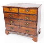 An 18thC oak chest, of two short and three long graduated cock beaded drawers, each with swan neck p