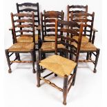 A set of seven (6+1) oak ladder back dining chairs, with rush seats, on turned legs joined by turned