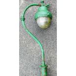 A 20thC cast iron free standing street light, the shaped bulb in domed casing, on a hook style faste