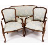 A heavily carved walnut salon suite, comprising settee with shaped back centred by carved rosettes,