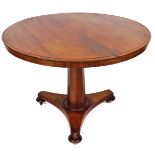 A Victorian mahogany breakfast table, the circular top with a plain outline on a shaped stem termina