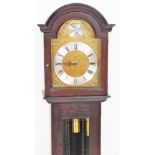 A 20thC mahogany finish Tempus Fugit grandmother clock, with arched dial and glazed trunk door, on a