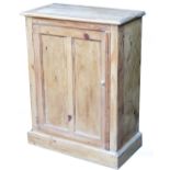 A reclaimed pine cupboard, of rectangular form with panelled front door, on a block base, 91cm high,