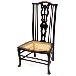 An early 20thC stained beech chair, with pierced back splat, bergere seat and cabriole front legs, w