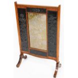 A late Victorian oak framed Art Nouveau fire screen, with central rectangular floral section and oxi