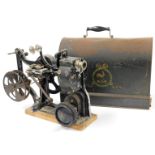 An early 20thC Pathe KOK 28mm projector, with articulated handle, with metal frame on pine base