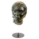 A 20thC spelter head sculpture formed as a lady, facing front on a plain stem and circular foot, 45c