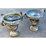A pair of stone classical urns, each of campana form, with leafy acanthus capped scroll handles, wit