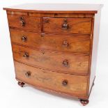A Victorian mahogany bow front chest, of two short and three long cock beaded drawers, each with kno