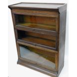 An early 20thC oak globe Wernicke style bookcase, in three sections on a moulded base with shaped co