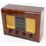 A mid 20thC Bush walnut cased radio, type AC II, with four front Bakelite tuning knops with a mesh f