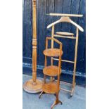 An oak three tier cake stand, 83cm high, a gentleman's coat hanger stand on turned supports terminat