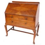 An early to mid 20thC oak bureau, the fall with diamond decoration, with a single drawer and pigeon