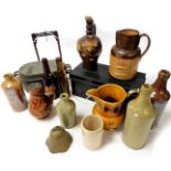 Various stoneware bottles and effects, a tin storage box, two coloured stoneware jug, porter's style