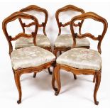A set of four Victorian rosewood dining chairs, each with shaped balloon backs, horizontal double sc