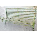 A 20thC wrought iron slatted railway style bench, with scroll arms and feet, 88cm high, 178cm wide,