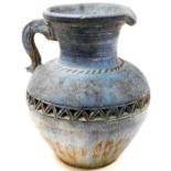A 20thC pottery Roman style ewer, of large proportion with lid top, tapering body raised with a geom
