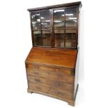 An George III mahogany bureau bookcase, the upper section with a pair of astragal glazed doors, rais