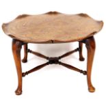 A 20thC oak and elm occasional table, with a fixed moulded top raised on cabriole legs, terminating