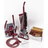 A vintage Legend Two Kirby vacuum cleaner, with chrome mounts in burgundy colours, 110cm high, with