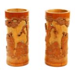 A pair of 20thC Chinese bamboo brush pots, of cylindrical form each raised with figures of hotei etc