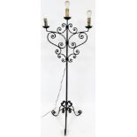 A 20thC wrought iron three branch lamp standard, on square stem terminating in triple scroll feet, 1