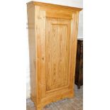 A reclaimed pine single wardrobe, with fixed moulded cornice, above a single panel door, on bracket