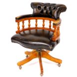 A late 20thC office captain's style swivel chair, with shaped back and arms, baluster supports, serp