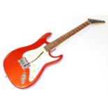 An Encore Coaster six string electric guitar, in red and white trim, 100cm wide.
