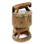 An African tribal headrest sculpture, with wild cat top, heavily carved cylindrical stem, resting on