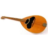 An early 20thC bouzouki, with elongated arm and shaped body with partial inlay and partially ebonis