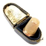 A 9ct gold thimble, of typical form, 2cm high, 3.5g. (in fitted case)