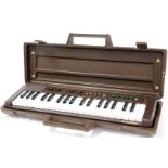 A Yamaha Portasound miniature keyboard, in fitted case, 51cm wide.