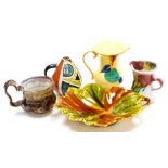 A Schramberg Majolica leaf shaped dish, with moulded handle, impressed mark beneath, 25cm wide, a De